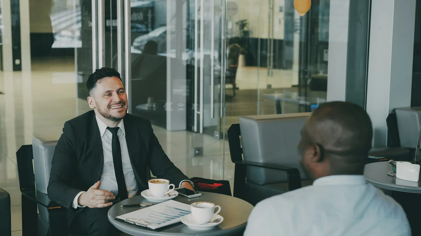 A coach recommending a product to a client during a training session, the moment a share of wellness demand is decided