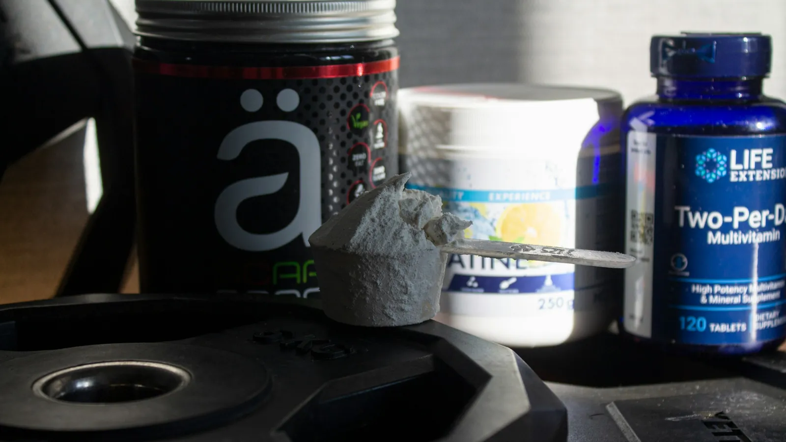 A supplement shelf stocked with protein tubs and vitamin bottles, the categories coaches recommend most